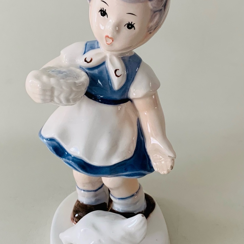 Vintage girl with chicken porcelain figurine